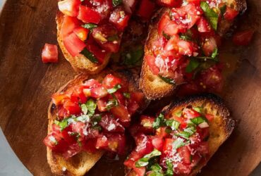 Fresh tomato bruschetta on toasted baguette slices topped with basil, garlic, and olive oil
