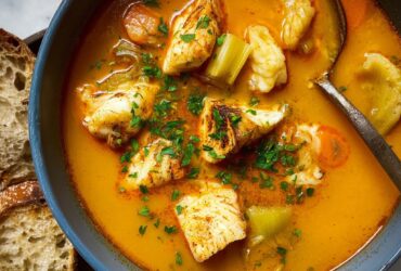 Traditional Provençal bouillabaisse with mixed fish, mussels, saffron broth, and crusty rouille toast
