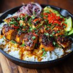 Spicy maple glazed chicken thighs over creamy coconut rice with cilantro, lime, and chili flakes