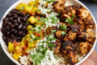 Cuban chicken and black bean rice bowl with cilantro lime rice, mojo-marinated chicken, plantains, and fresh cilantro