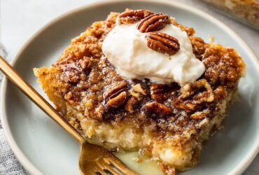 Pecan pie dump cake with golden caramel pecan topping, buttery yellow cake crumb, served warm with vanilla ice cream