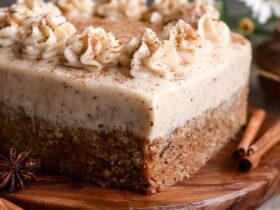 Ultra-moist chai cake with brown butter cream cheese frosting, cinnamon dust, candied ginger, and visible chai-milk-soaked layers