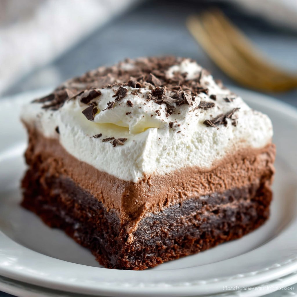 Chocolate French silk brownies with fudgy brownie base, light silky chocolate mousse middle, whipped cream top, and chocolate shavings
