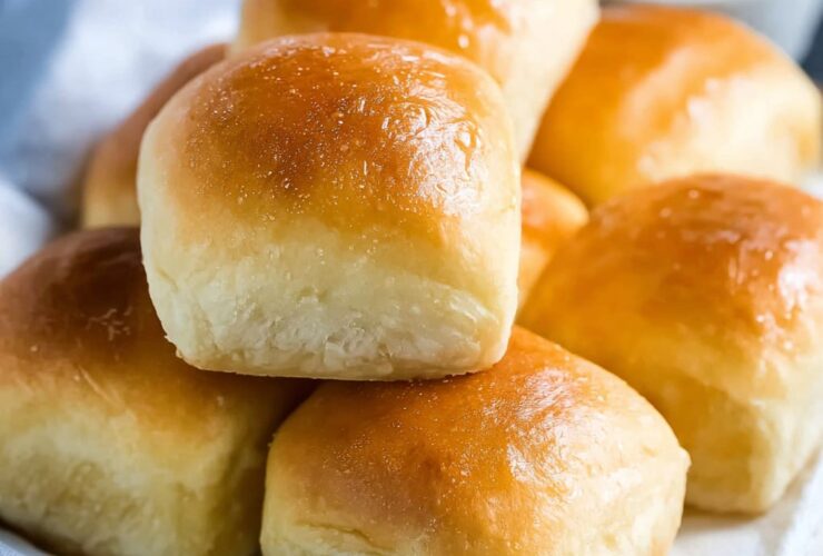 Texas Roadhouse rolls with golden buttery tops, sweet brioche-like interior, served with cinnamon honey butter spread on the side