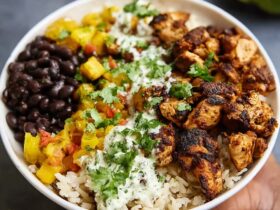 Cuban chicken rice bowl with mojo-marinated chicken thighs over cilantro-lime rice with seasoned black beans, plantains, and avocado