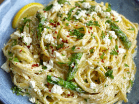 Creamy lemon feta pasta in a white bowl with rigatoni coated in lemony cream sauce, melted feta, fresh dill, lemon zest, cracked pepper