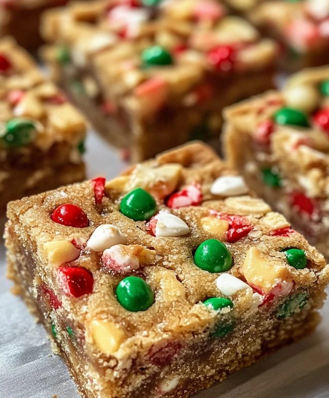 Holiday cookie bars cut into squares on parchment paper, soft buttery sugar cookie base with thick swirly cream cheese frosting layer on top, colorful red green and white festive sprinkles covering everything, cookie tin with more bars beside
