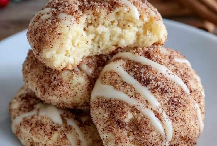 Soft cinnamon sugar cream cheese cookies stacked on a marble surface, crackled cinnamon-sugar tops, pillowy soft centers visible in a broken cookie, warm afternoon light