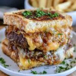 Grilled cheese burger sandwich cut in half, a juicy beef patty with melted cheese sandwiched between two golden buttery grilled cheese sandwiches, cheese pulling apart